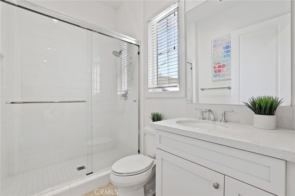 74 Egret Irvine, CA 92618 - Photo 31 of 74 a bathroom with a granite countertop sink a toilet and shower