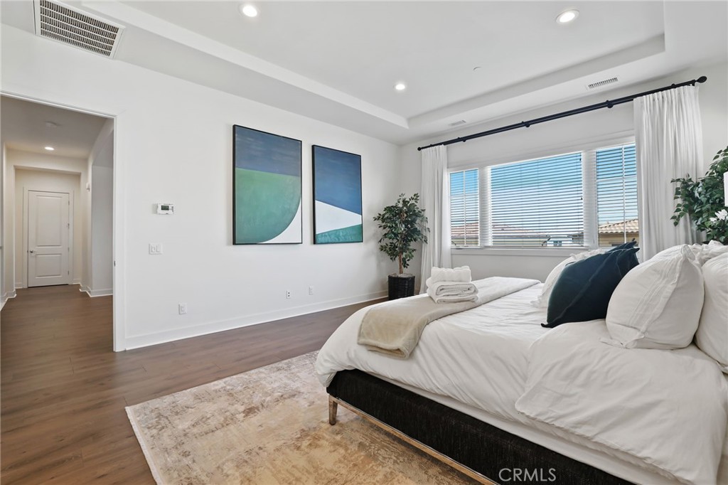74 Egret Irvine, CA 92618 - Photo 48 of 74 a bedroom with a large bed and a potted plant