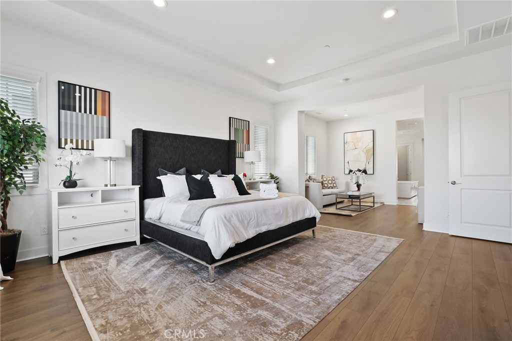 74 Egret Irvine, CA 92618 - Photo 49 of 74 a spacious bedroom with a bed and a couch