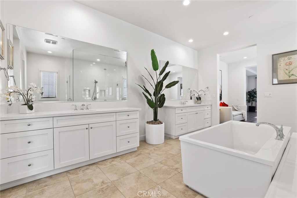74 Egret Irvine, CA 92618 - Photo 55 of 74 a bathroom with a double vanity sink a mirror and a bathtub