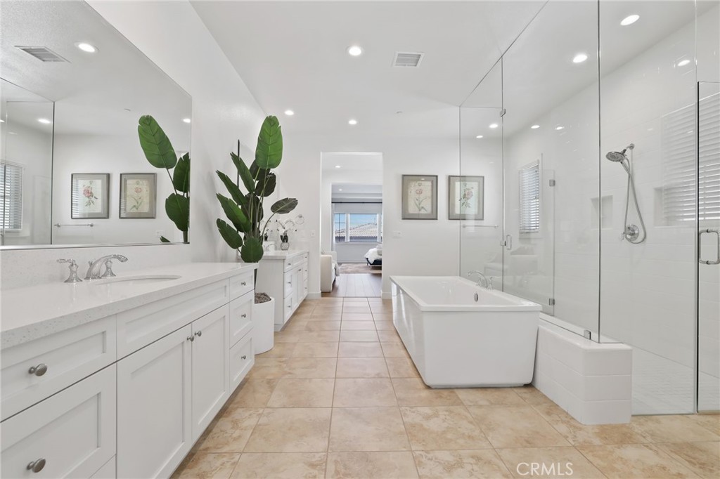 74 Egret Irvine, CA 92618 - Photo 56 of 74 a spacious bathroom with a double vanity sink a bathtub and a shower
