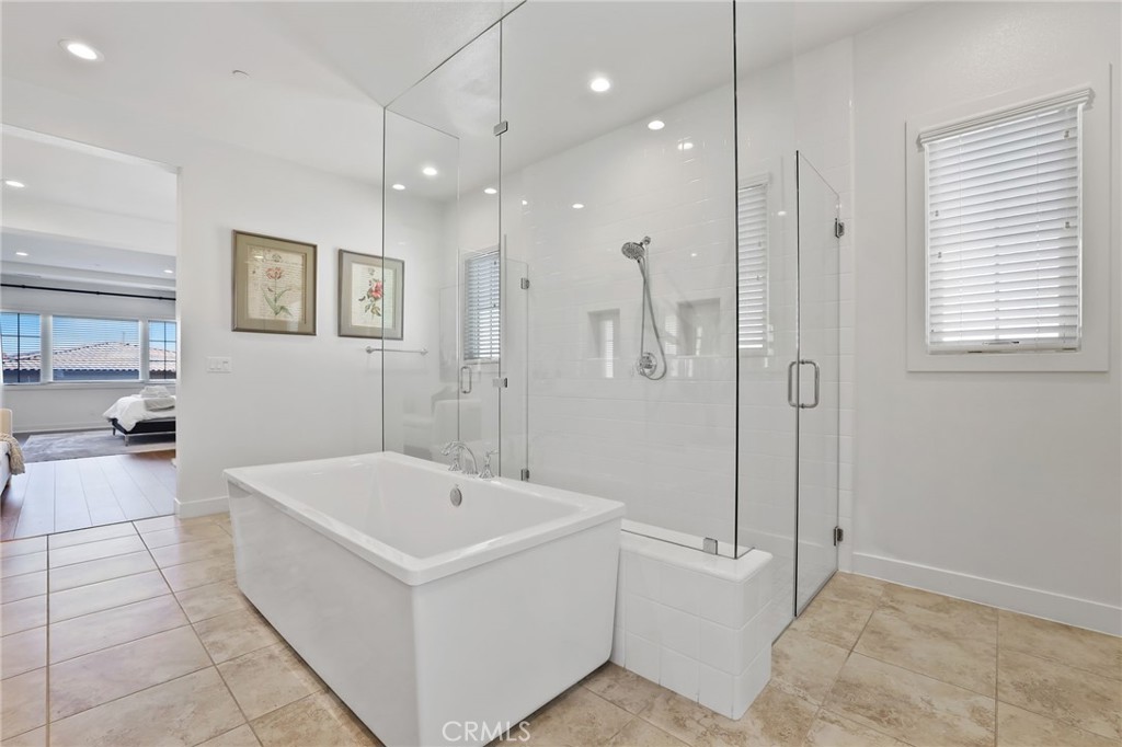 74 Egret Irvine, CA 92618 - Photo 57 of 74 a bathroom with a tub a sink a mirror and a shower