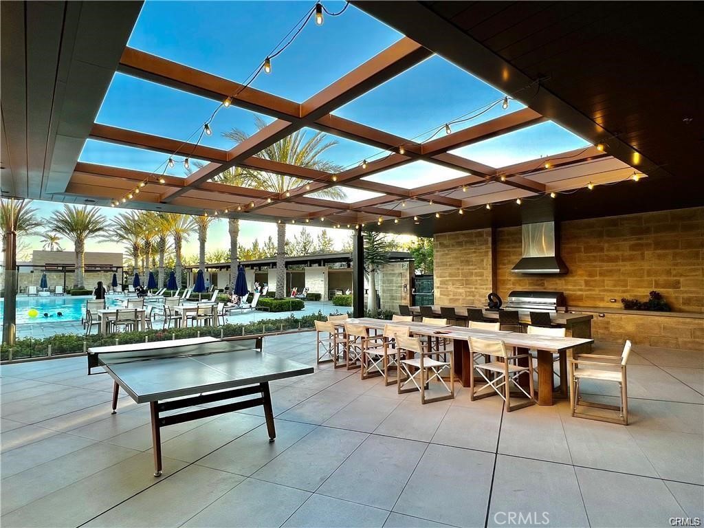 74 Egret Irvine, CA 92618 - Photo 74 of 74 a outdoor space with lots of tables a chair and a fireplace