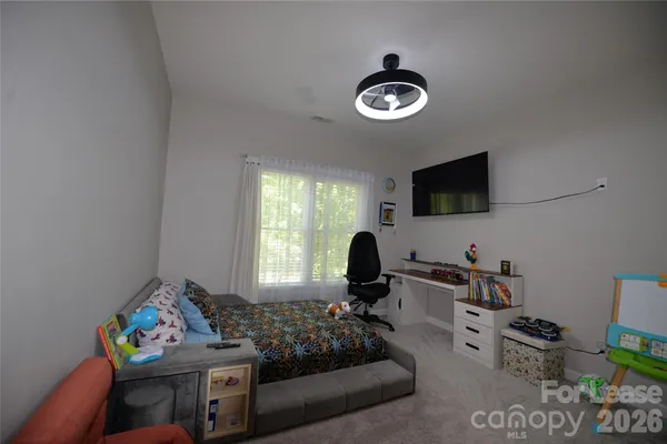 a spacious bedroom with a bed and a window