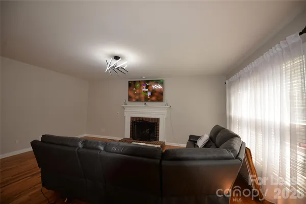 a large kitchen with granite countertop stainless steel appliances and wooden floor