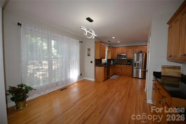 a kitchen with stainless steel appliances granite countertop a refrigerator and a sink