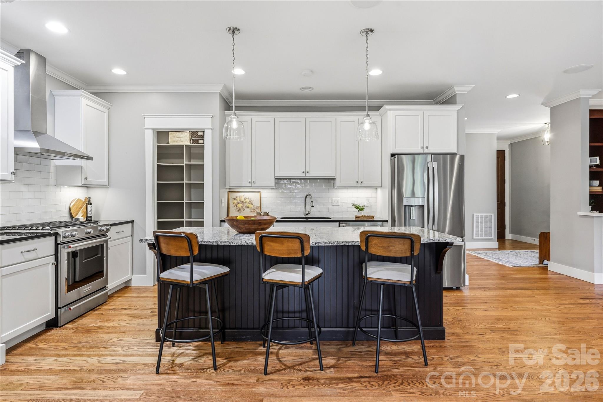 30 Still Creek Loop Fairview, NC 28730 - Photo 4 of 45 a kitchen with stainless steel appliances kitchen island granite countertop a dining table chairs refrigerator and sink