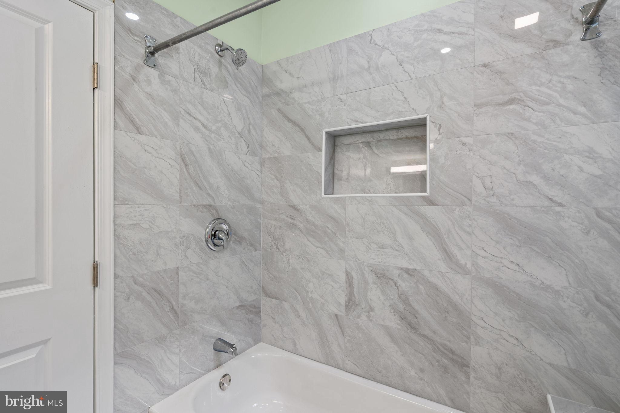 1937 South Lambert Street Philadelphia, PA 19145 - Photo 23 of 34 Sleek marble shower with modern fixtures.
