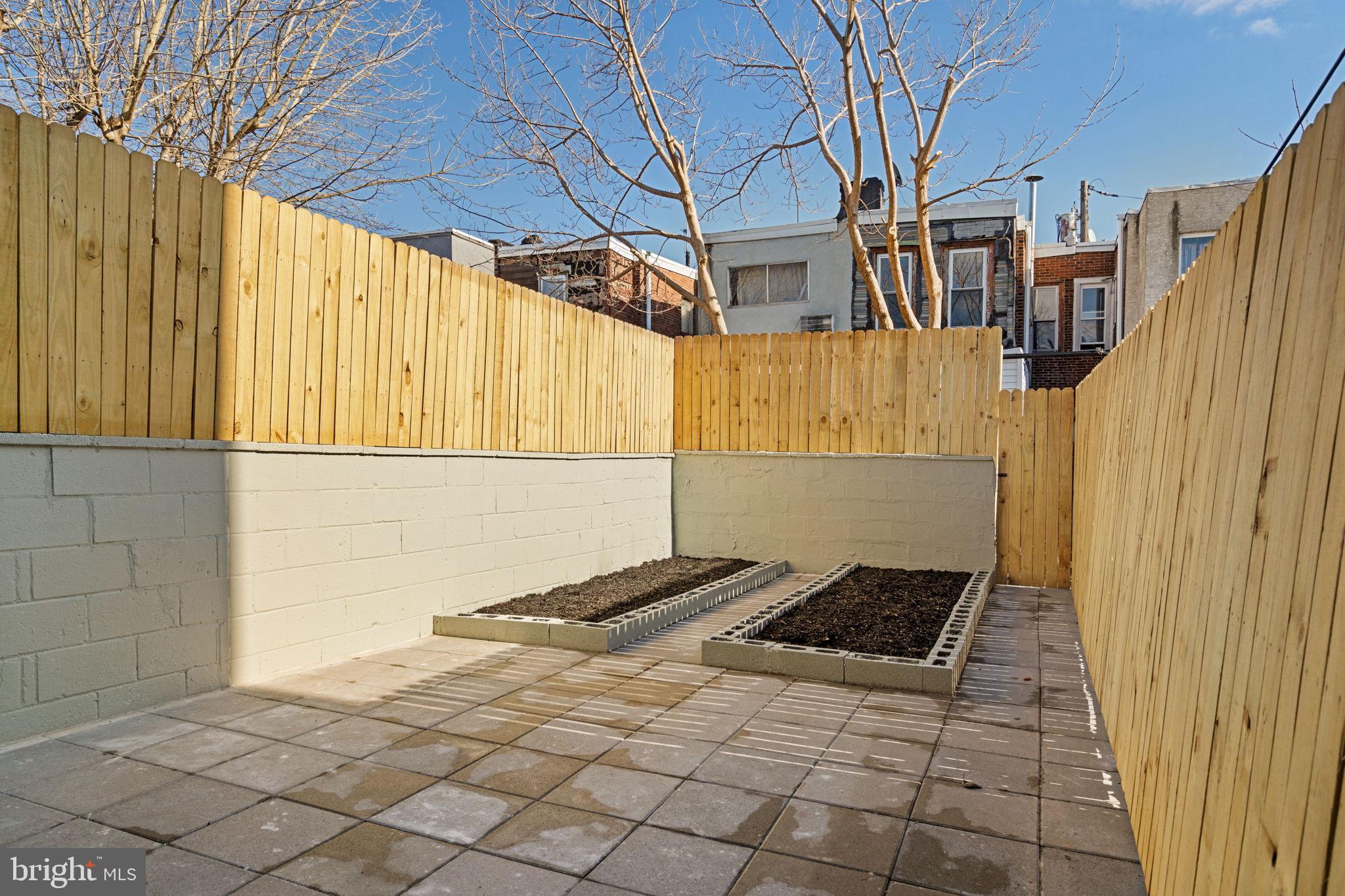 1937 South Lambert Street Philadelphia, PA 19145 - Photo 26 of 34 Sunny urban garden retreat with wooden fencing.