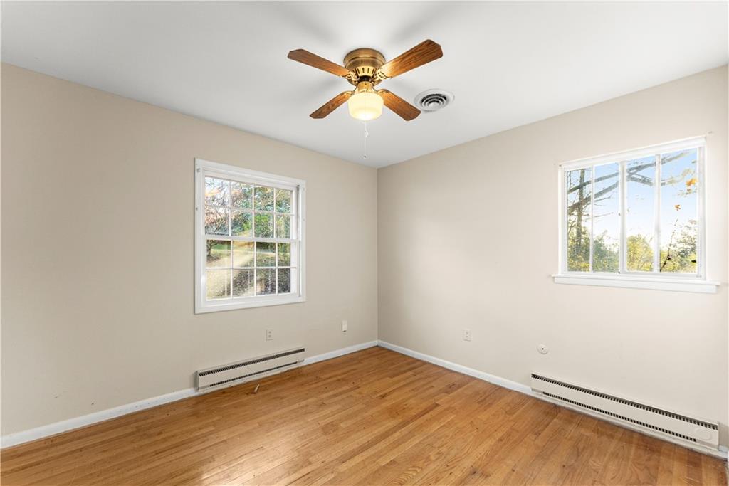 660 Honeysuckle Road Gainesville, GA 30501 - Photo 11 of 43 wooden floor in an empty room with a window