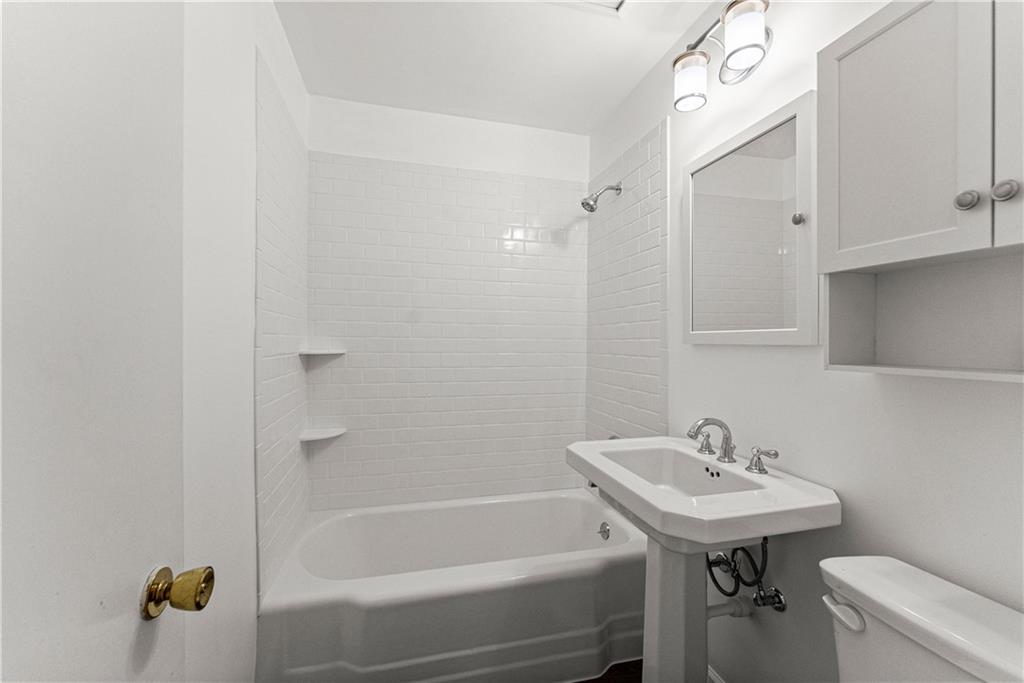 660 Honeysuckle Road Gainesville, GA 30501 - Photo 19 of 43 a bathroom with a sink a toilet and shower