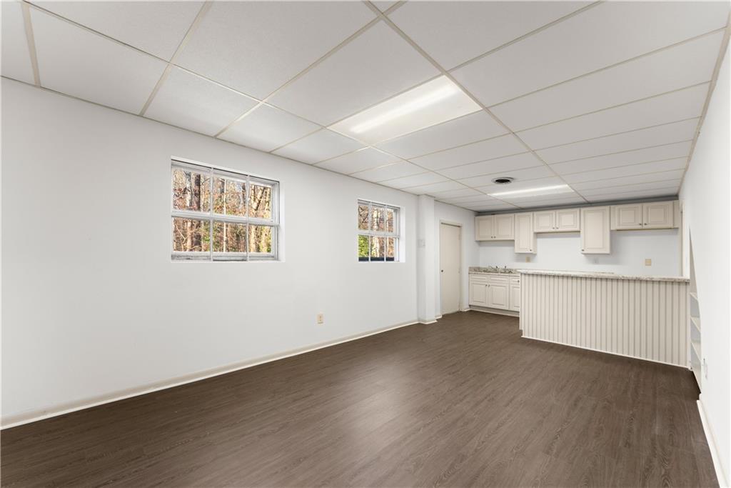 660 Honeysuckle Road Gainesville, GA 30501 - Photo 20 of 43 an empty room with wooden floor and windows