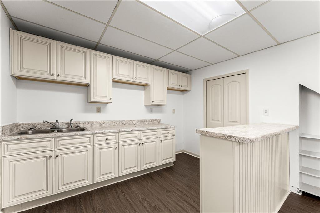 660 Honeysuckle Road Gainesville, GA 30501 - Photo 22 of 43 a kitchen with granite countertop white cabinets and white appliances