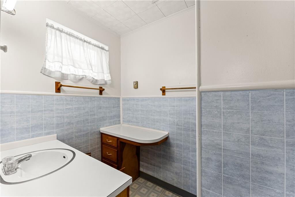 660 Honeysuckle Road Gainesville, GA 30501 - Photo 24 of 43 a bathroom with a tub a sink and a window