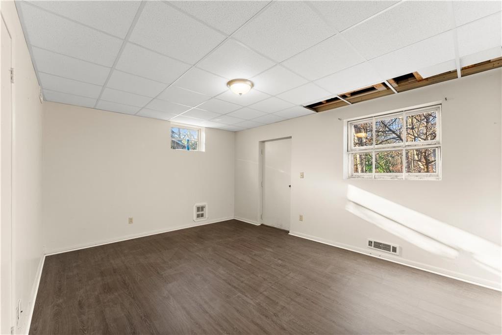 660 Honeysuckle Road Gainesville, GA 30501 - Photo 27 of 43 an empty room with wooden floor and windows