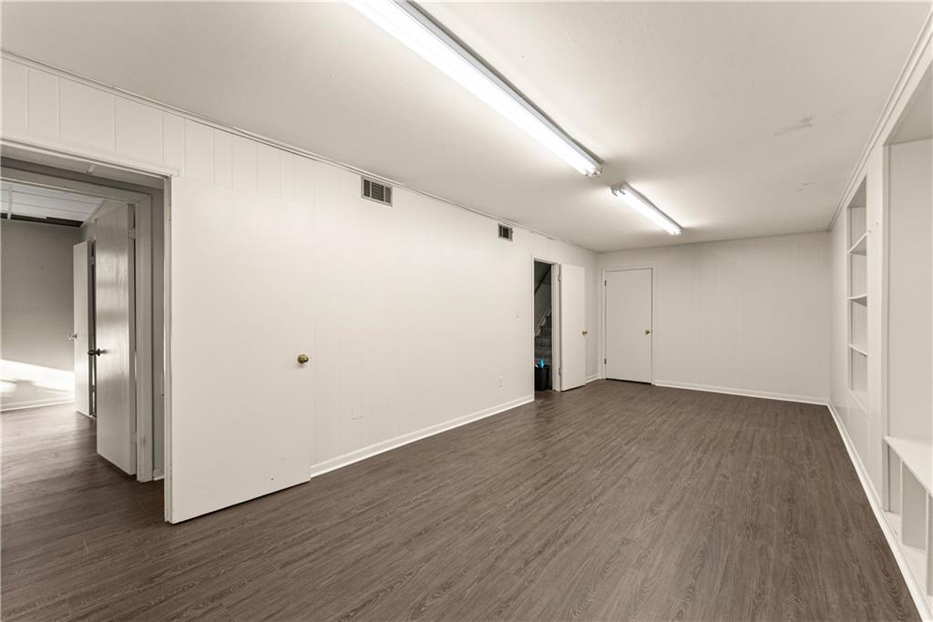660 Honeysuckle Road Gainesville, GA 30501 - Photo 31 of 43 an empty room with wooden floor and windows