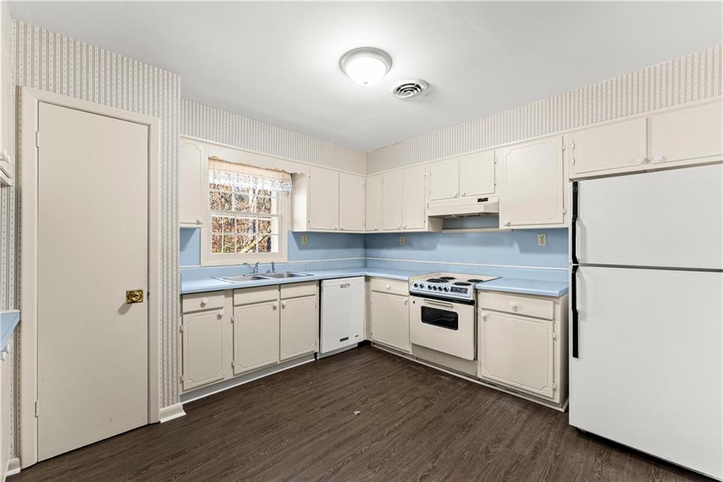 660 Honeysuckle Road Gainesville, GA 30501 - Photo 7 of 43 a kitchen with granite countertop white cabinets and white appliances