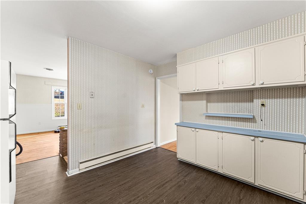 660 Honeysuckle Road Gainesville, GA 30501 - Photo 8 of 43 a kitchen with granite countertop white cabinets and wooden floor