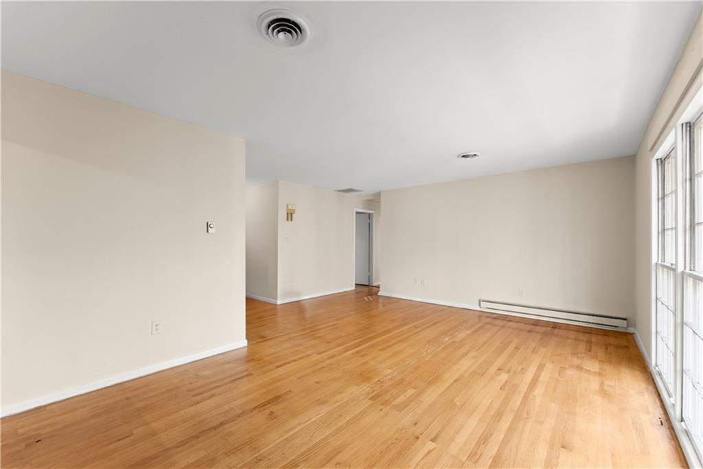 660 Honeysuckle Road Gainesville, GA 30501 - Photo 9 of 43 an empty room with wooden floor and windows