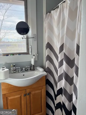 a bathroom with a toilet a sink and mirror