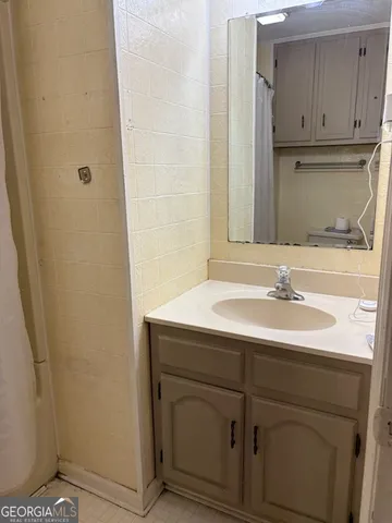 a bathroom with a granite countertop toilet and a sink