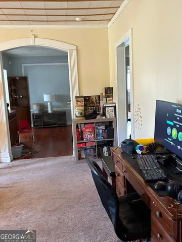 a view of a livingroom with furniture and a view of kitchen