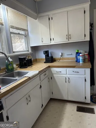 a kitchen with a stove sink and a refrigerator