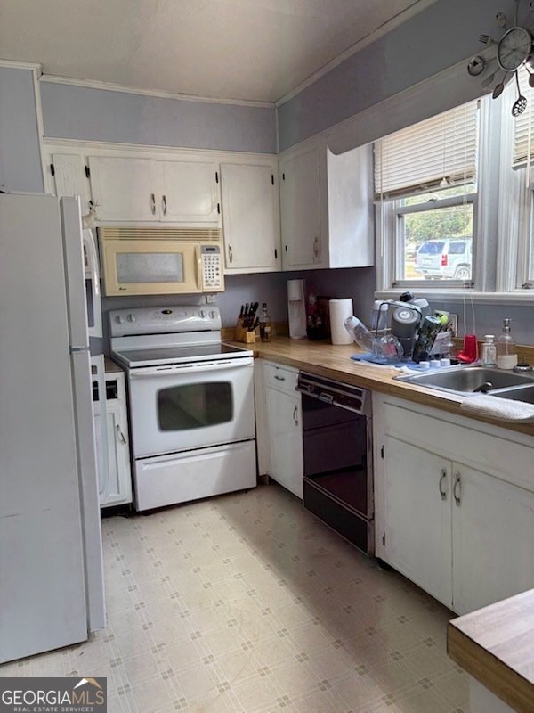 508 Pine Street West Point, GA 31833 - Photo 10 of 22 a kitchen with a stove sink and a refrigerator