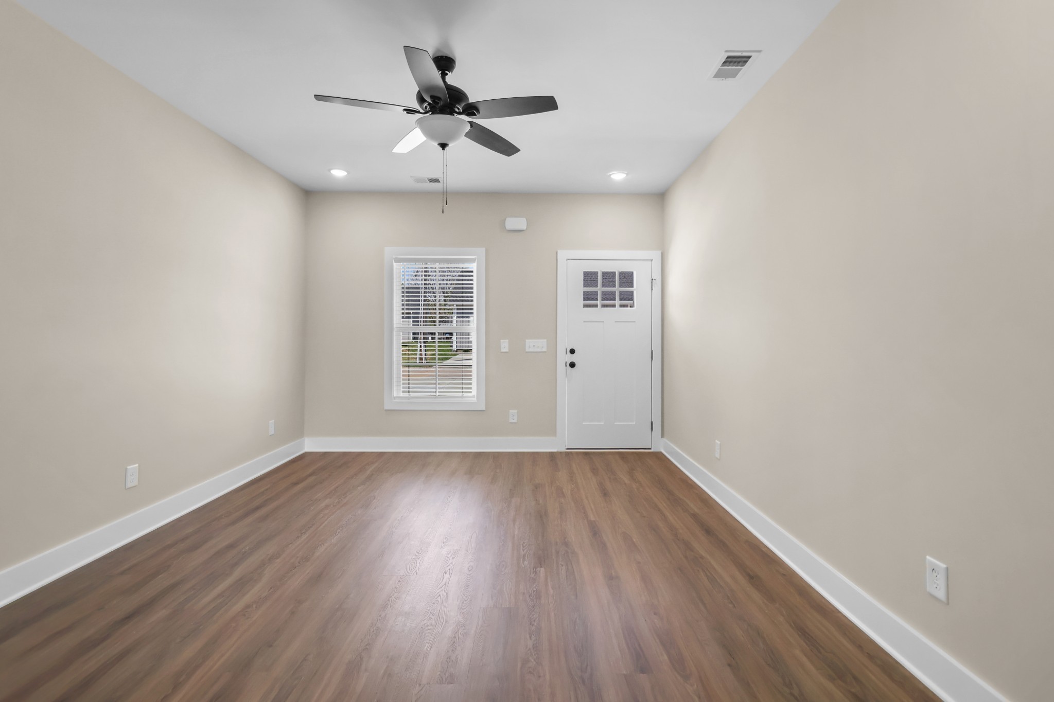 1004 Oak Street, Unit B Portland, TN 37148 - Photo 11 of 29 an empty room with wooden floor and windows