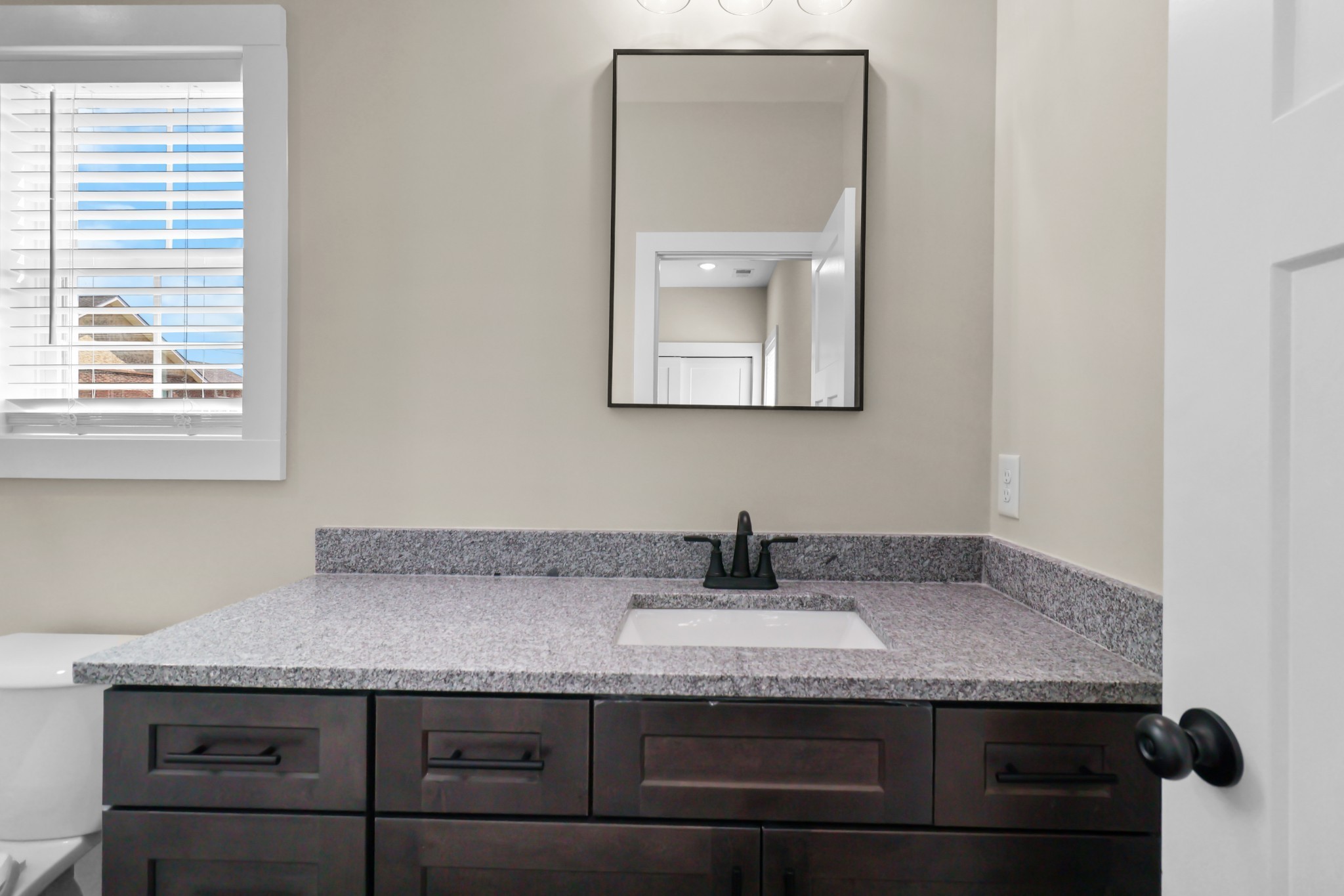 1004 Oak Street, Unit B Portland, TN 37148 - Photo 17 of 29 a sink with granite countertop a sink and a mirror