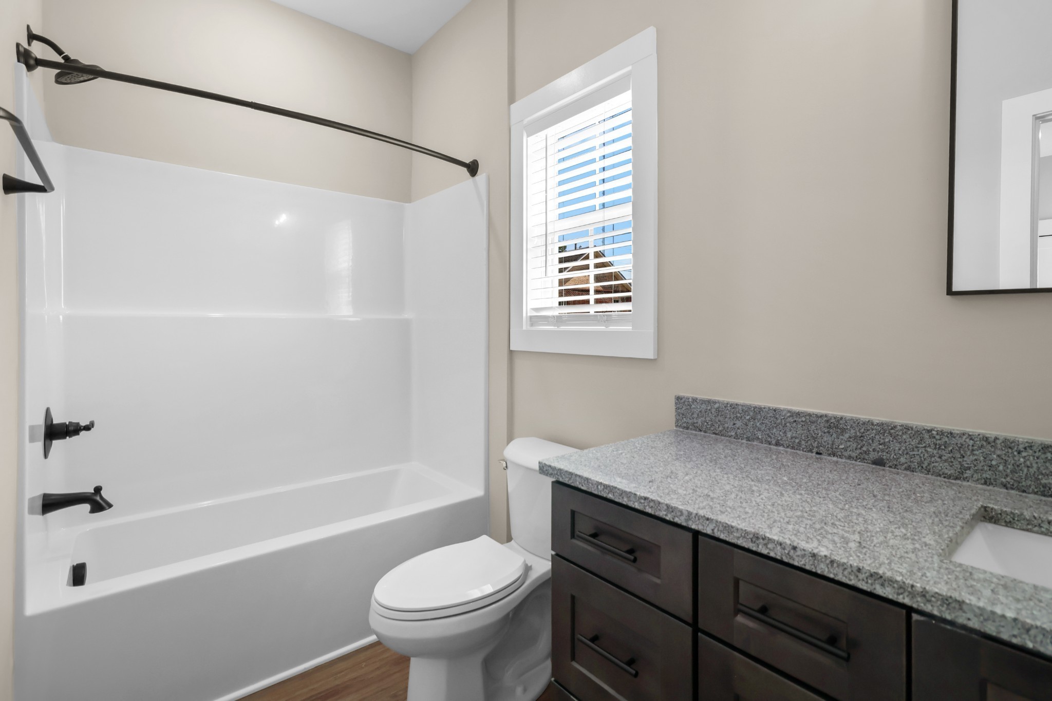 1004 Oak Street, Unit B Portland, TN 37148 - Photo 18 of 29 a bathroom with a granite countertop sink toilet and shower