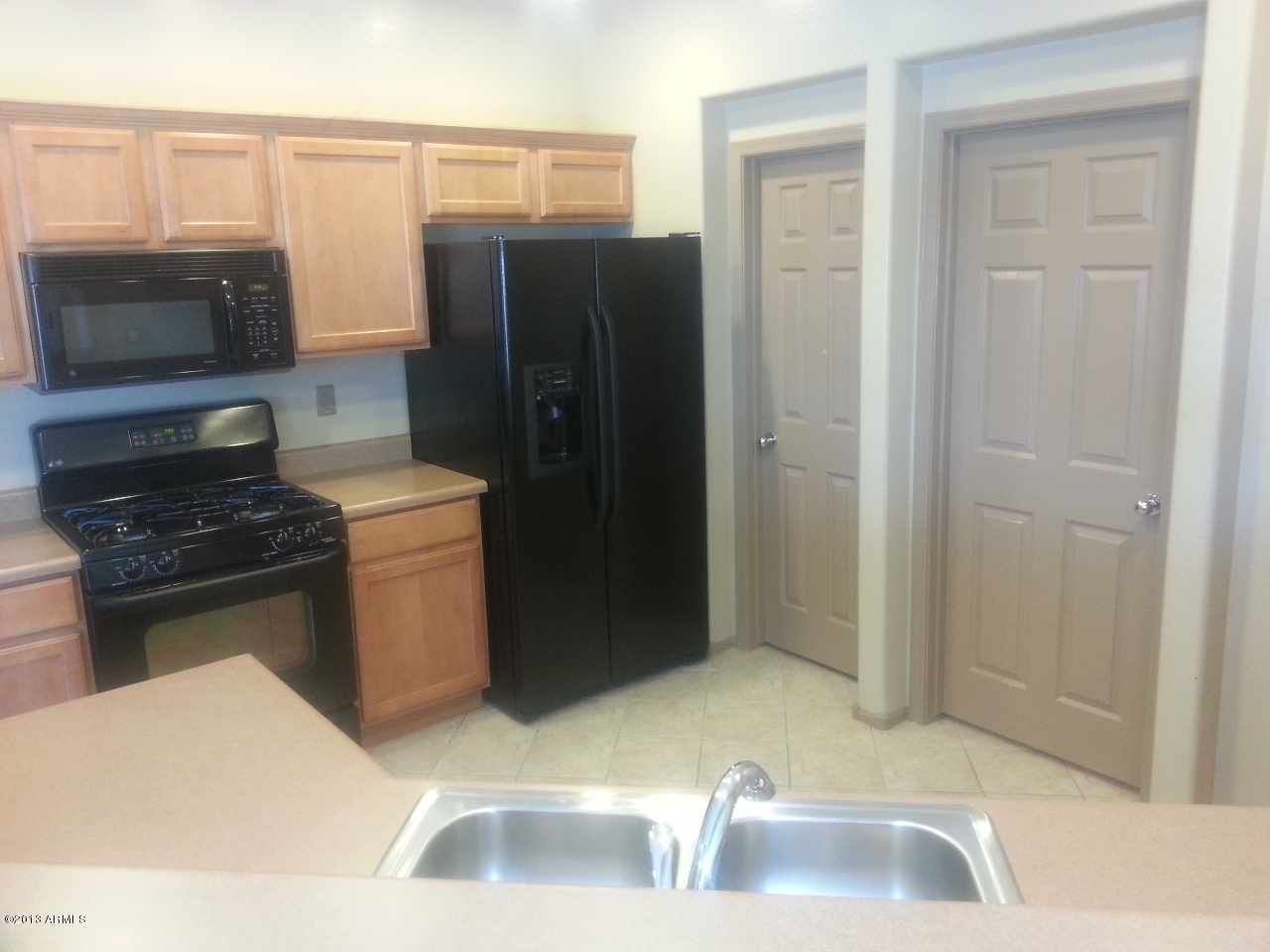 44395 Cypress Lane Maricopa, AZ 85138 - Photo 7 of 20 a kitchen with a refrigerator and a sink