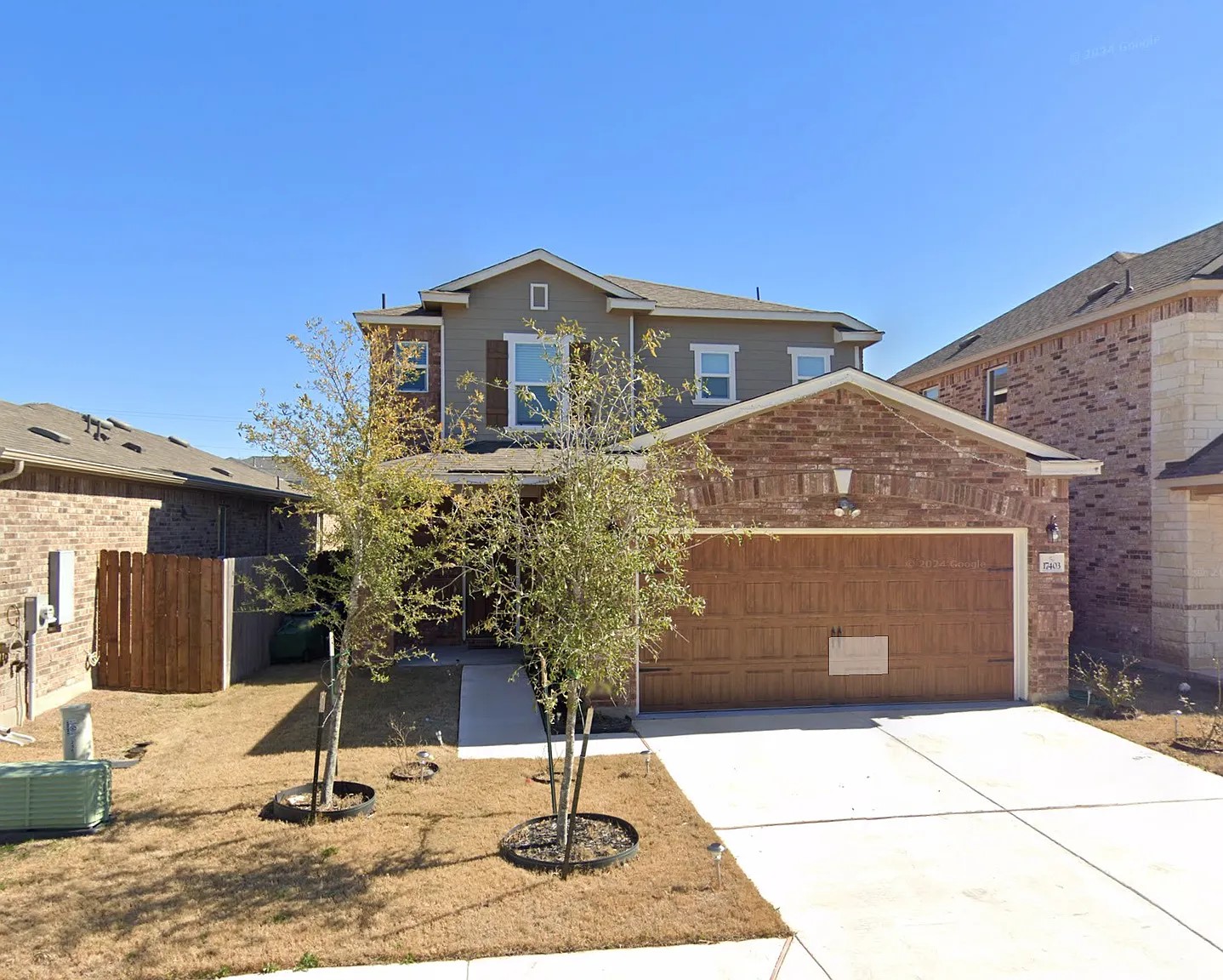 17403 Headstock Road Round Rock, TX 78664 - Photo 1 of 16 A classic brick-front home with a rich wooden garage door offers inviting curb appeal.