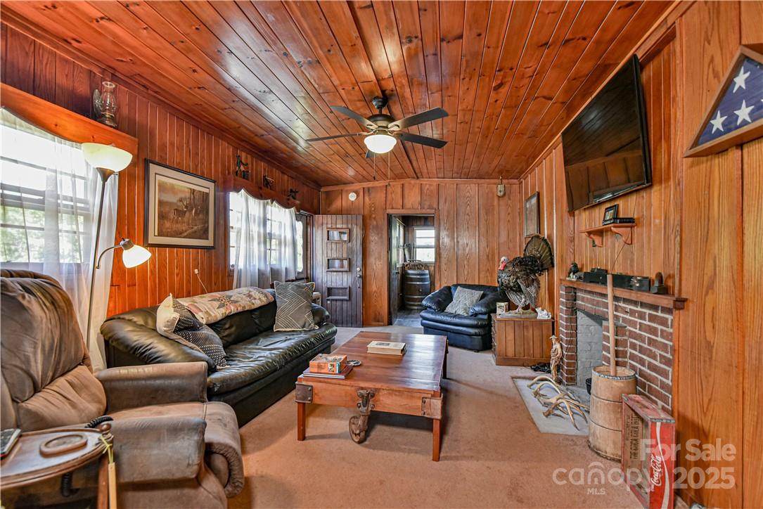 415 Weaverville Road Asheville, NC 28804 - Photo 18 of 47 a living room with furniture a ceiling fan and a window