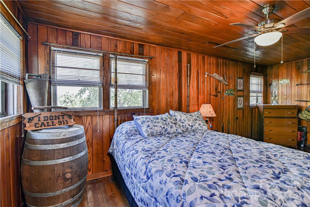415 Weaverville Road Asheville, NC 28804 - Photo 19 of 47 a bedroom with a bed and a dresser