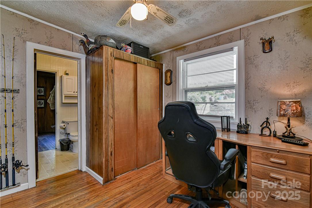415 Weaverville Road Asheville, NC 28804 - Photo 24 of 47 a view of a workspace with wooden floor and windows