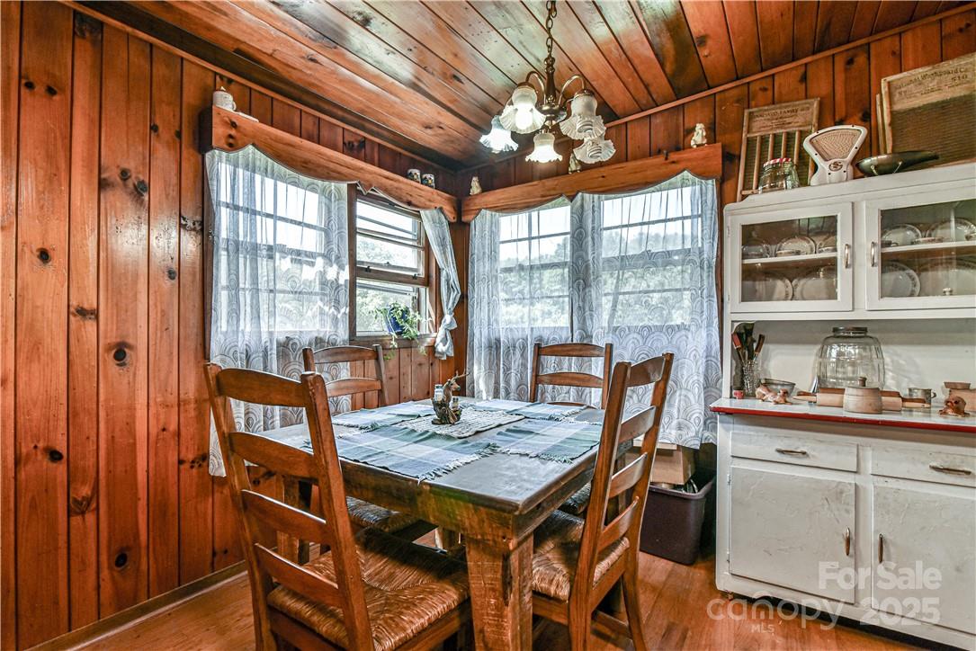 415 Weaverville Road Asheville, NC 28804 - Photo 25 of 47 a view of a dining room with furniture window and wooden floor