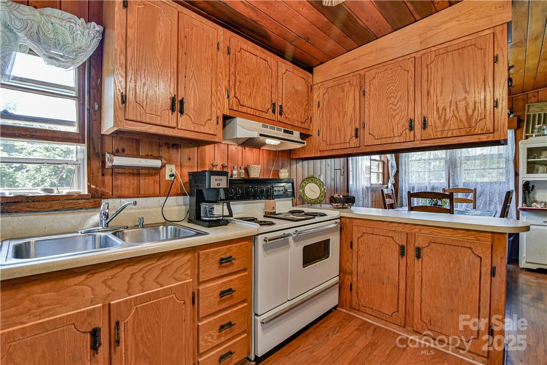 415 Weaverville Road Asheville, NC 28804 - Photo 27 of 47 a kitchen with stainless steel appliances granite countertop a sink and cabinets