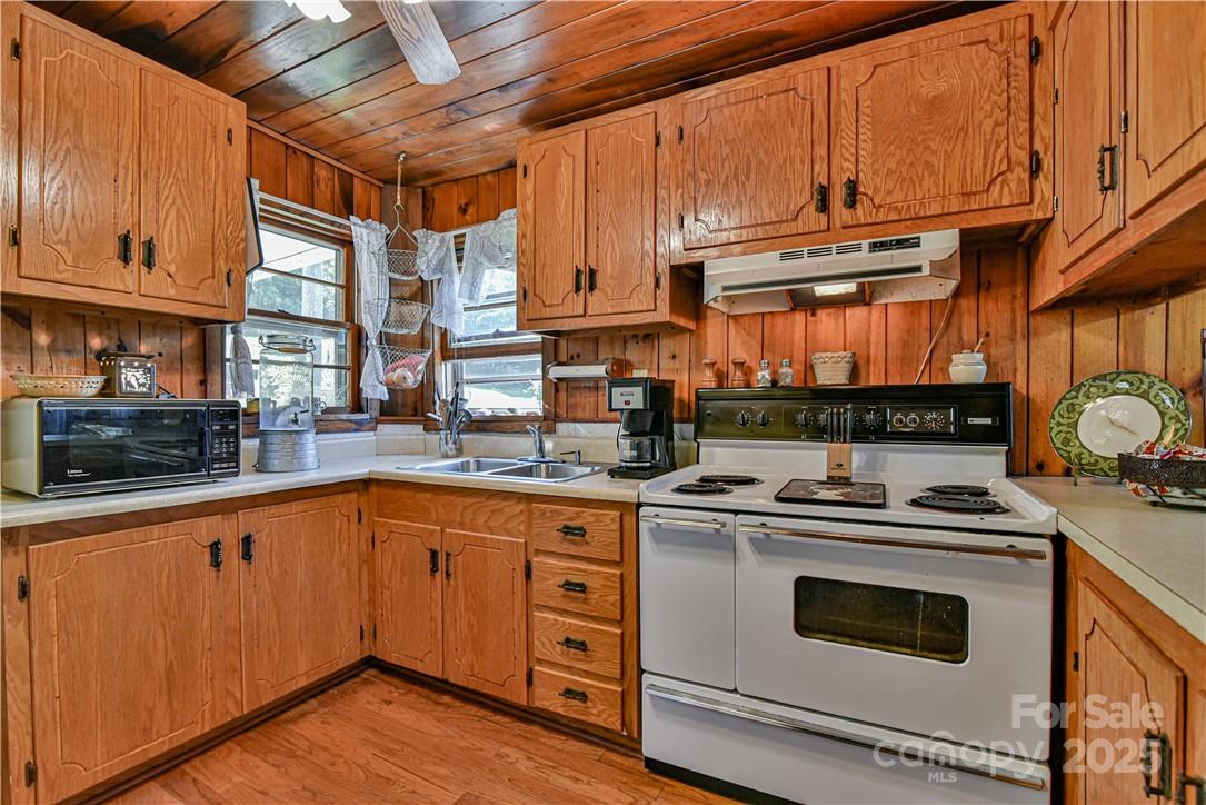 415 Weaverville Road Asheville, NC 28804 - Photo 28 of 47 a kitchen with stainless steel appliances granite countertop a stove and a sink