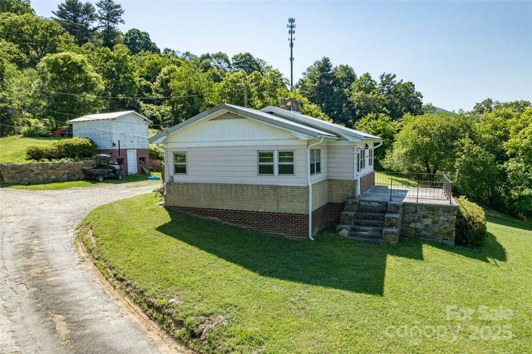 415 Weaverville Road Asheville, NC 28804 - Photo 35 of 47 a front view of a house with garden