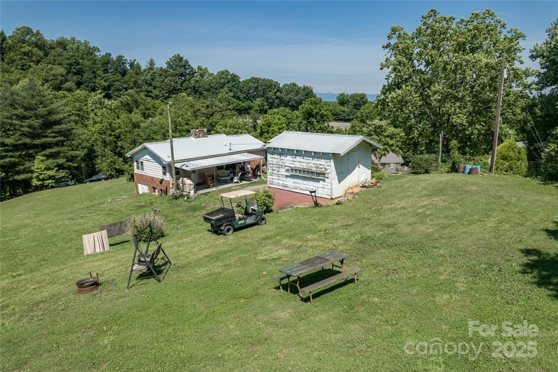 415 Weaverville Road Asheville, NC 28804 - Photo 42 of 47 an aerial view of a house with backyard space and garden