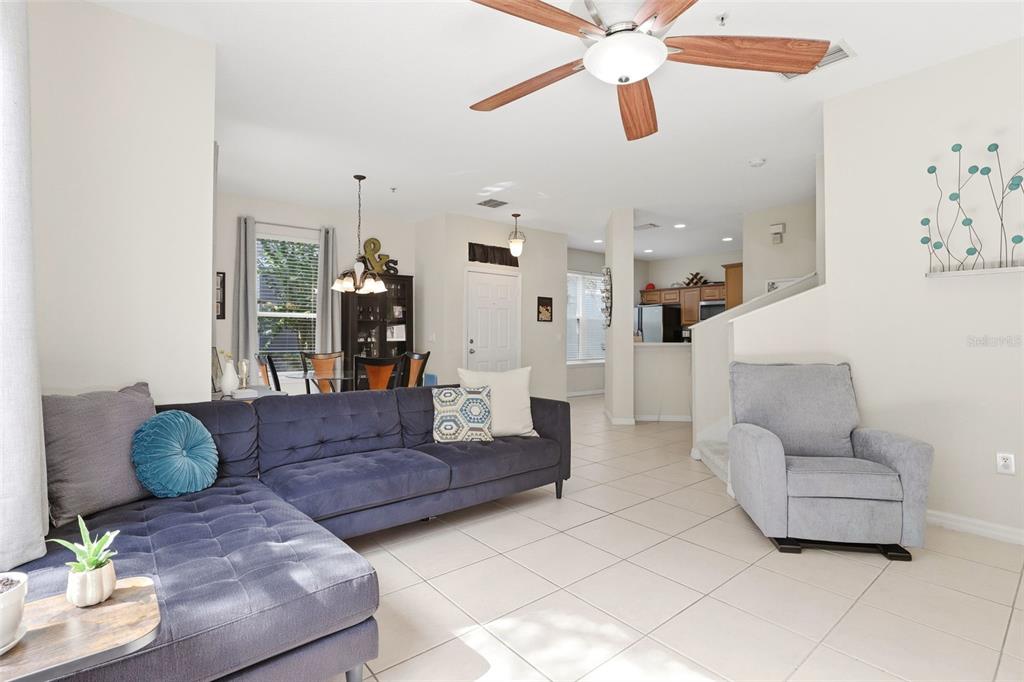 6458 South Goldenrod Road, Unit 29B Orlando, FL 32822 - Photo 9 of 40 a living room with furniture and a chandelier