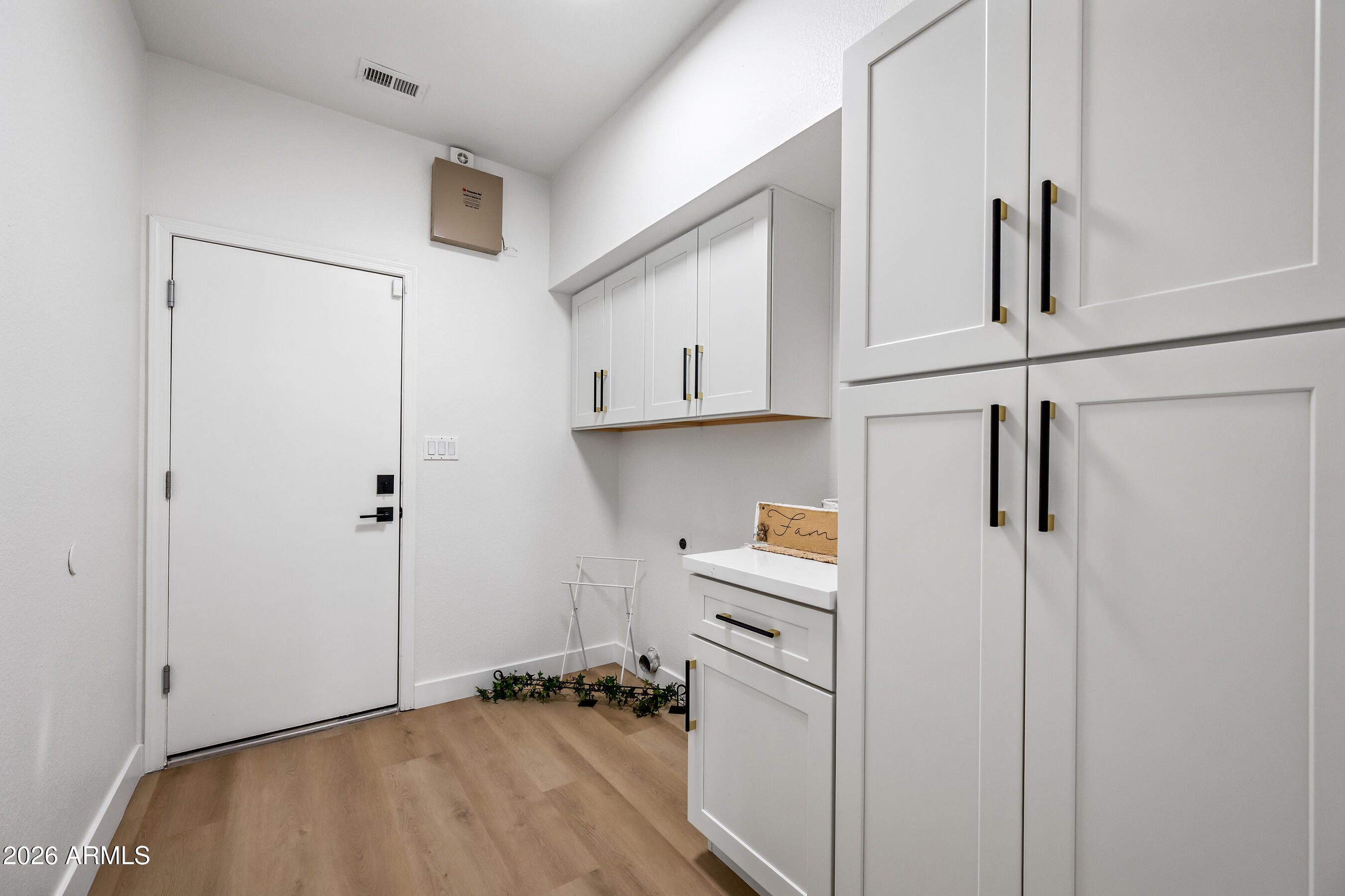 815 East Desert Trumpet Road Phoenix, AZ 85048 - Photo 16 of 57 Indoor Laundry Room with Cabinets