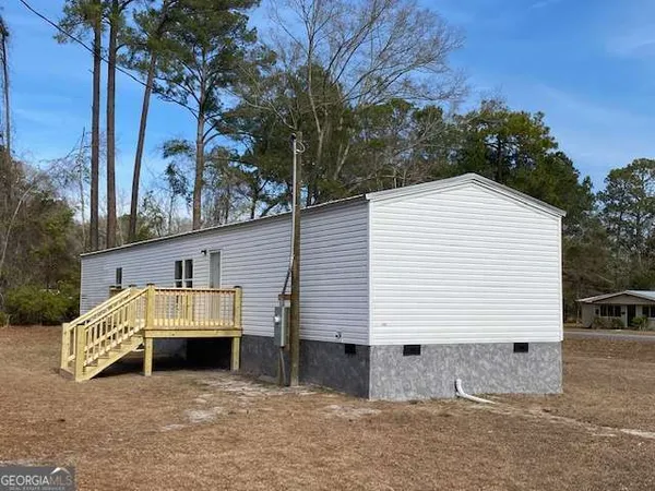 a view of a house with a yard and garage