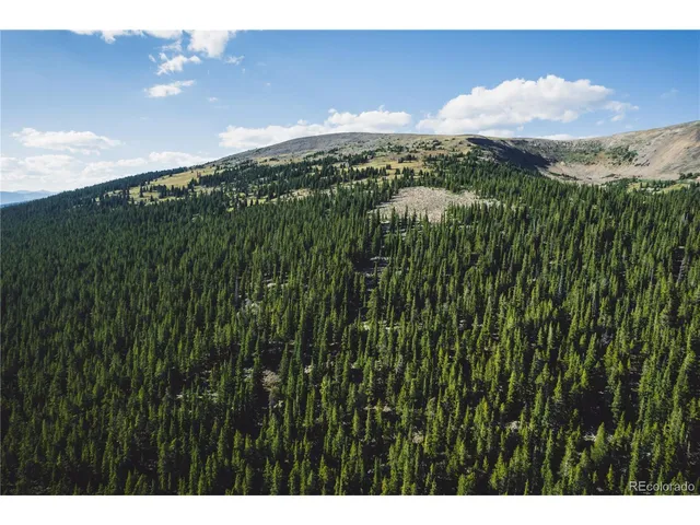 a view of a yard in front of mountains