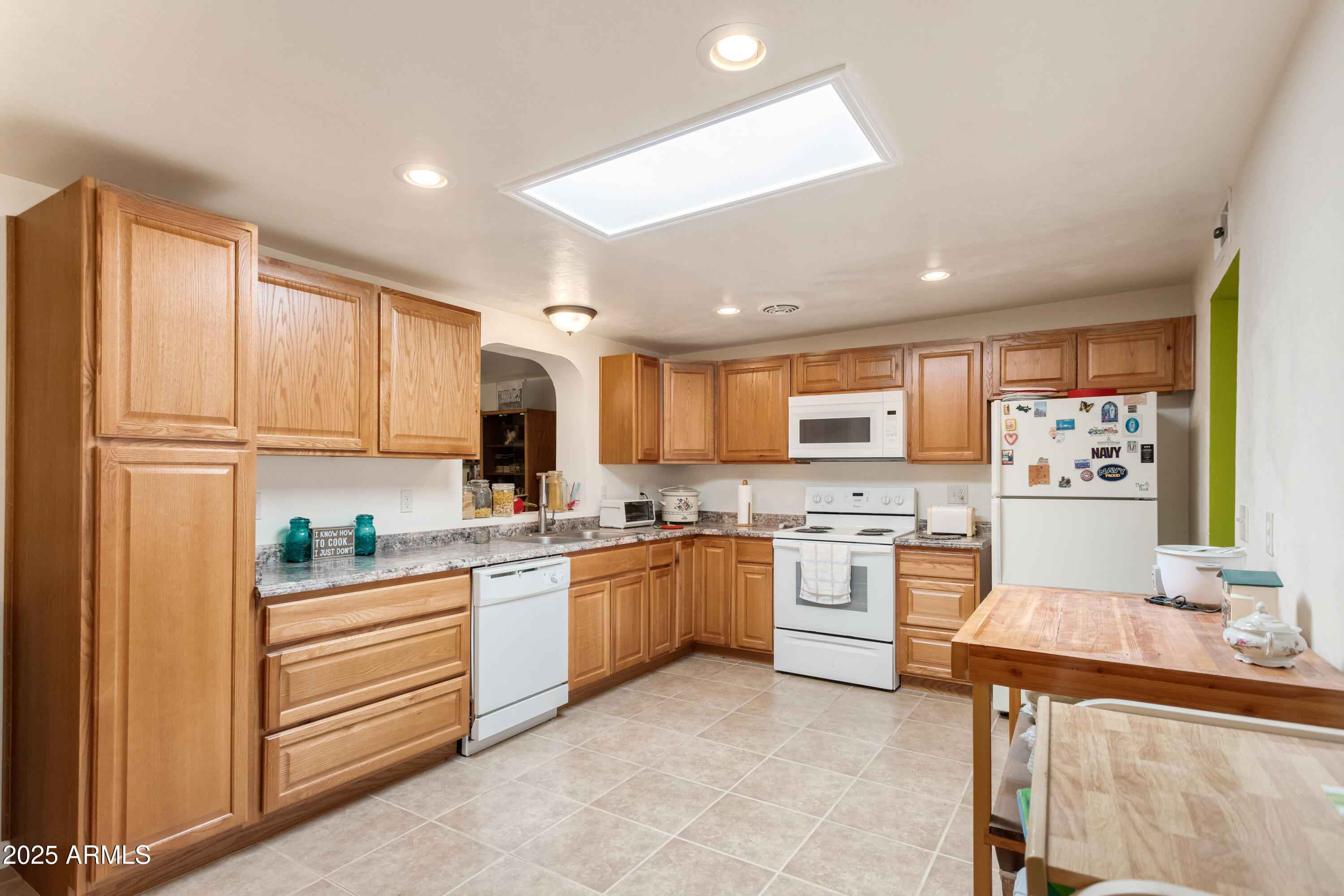 4964 East Raffaele Avenue Sierra Vista, AZ 85635 - Photo 13 of 41 a kitchen with stainless steel appliances granite countertop a stove top oven a sink dishwasher and a refrigerator with wooden floor
