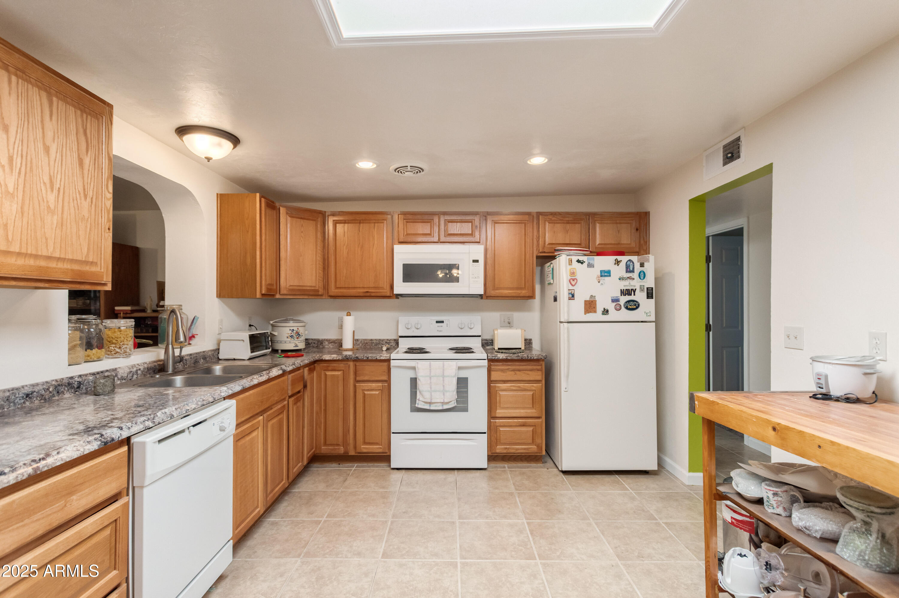 4964 East Raffaele Avenue Sierra Vista, AZ 85635 - Photo 15 of 41 a kitchen with stainless steel appliances granite countertop a stove sink and cabinets