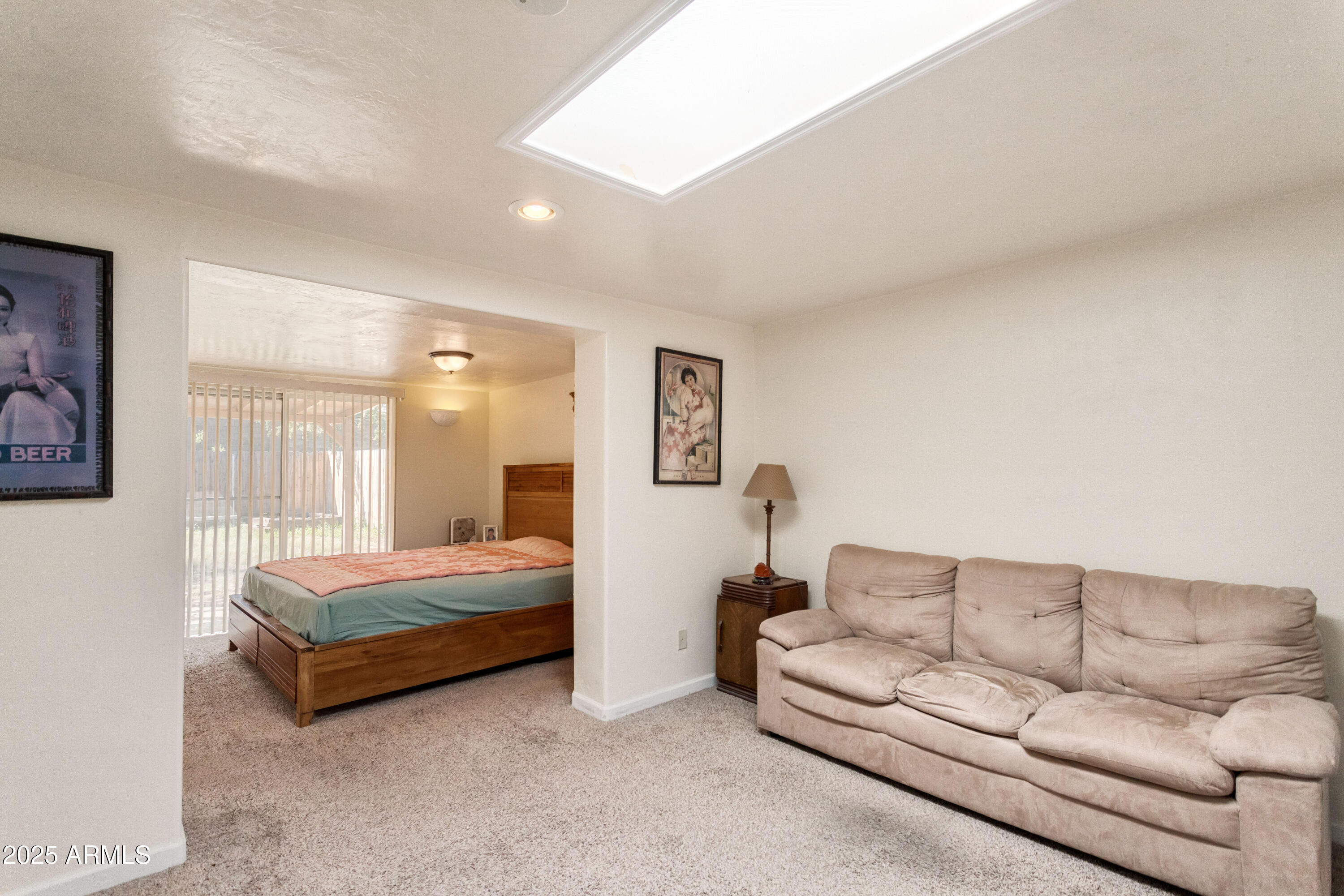 4964 East Raffaele Avenue Sierra Vista, AZ 85635 - Photo 16 of 41 a spacious bedroom with a bed couch and window