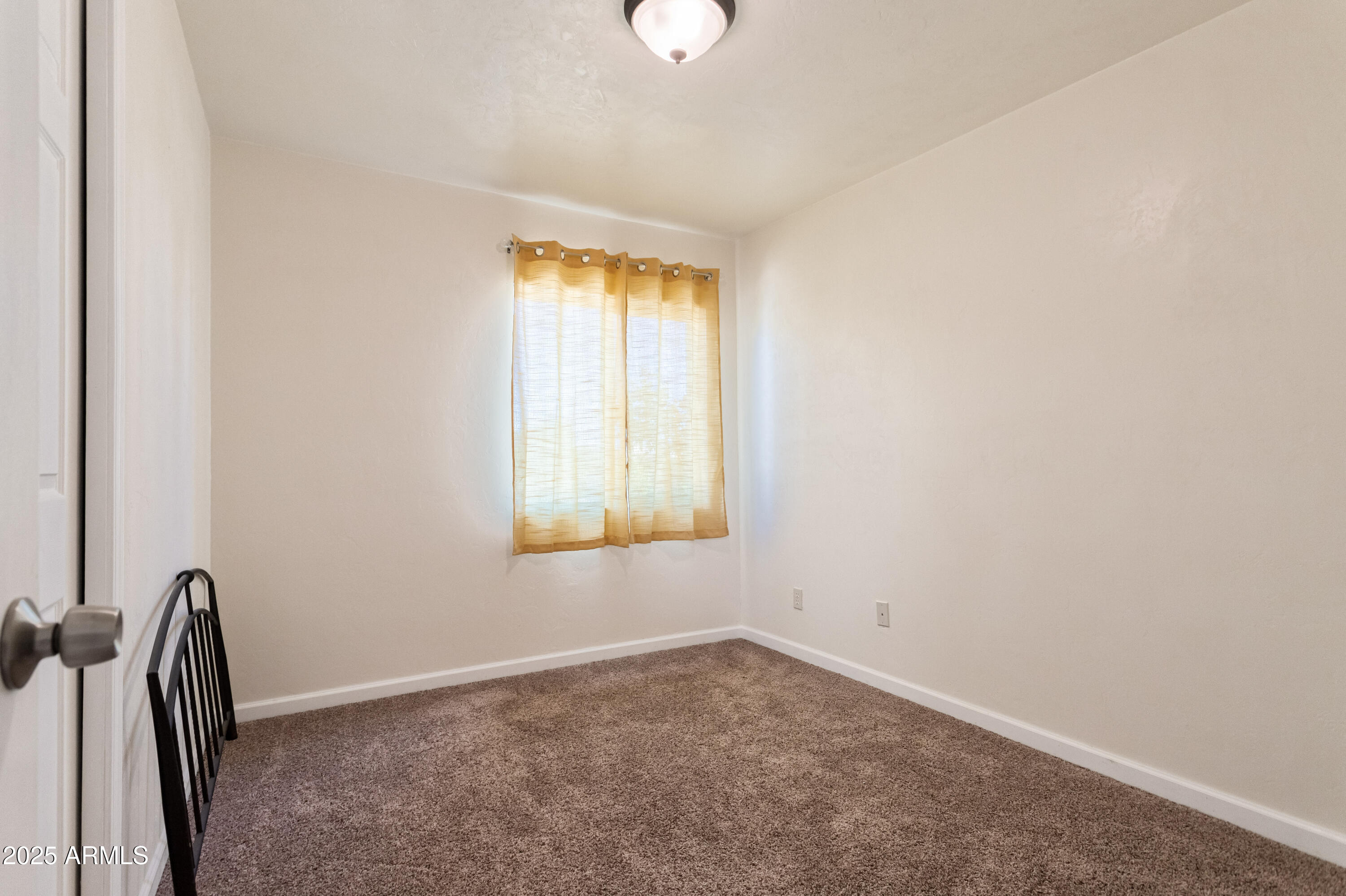 4964 East Raffaele Avenue Sierra Vista, AZ 85635 - Photo 23 of 41 a view of an empty room with a window