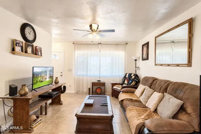 a living room with furniture a rug and a window